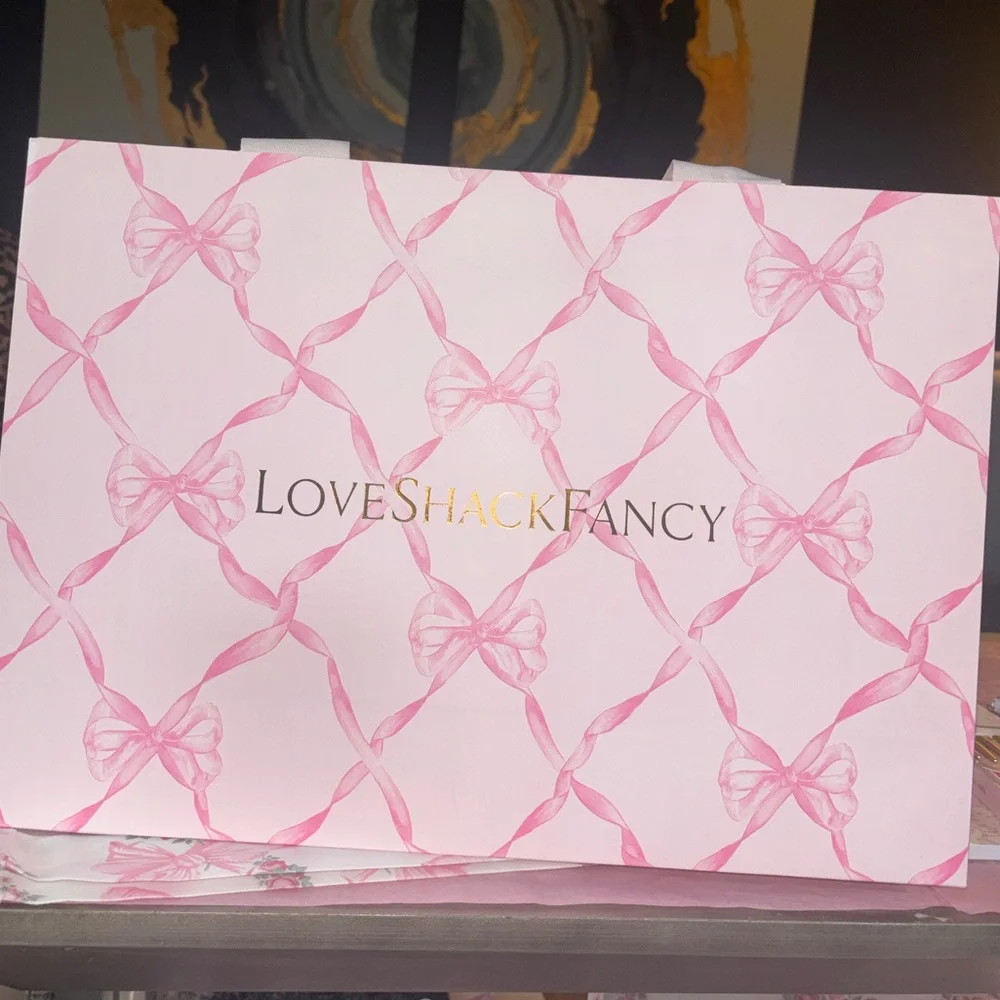 LoveShackFancy pink shopping gift bags with pink ribbon bow pattern